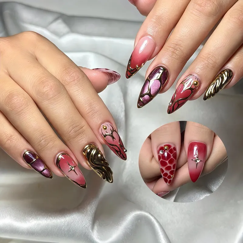Stiletto nails in red, chrome and gold with a mix of patterns